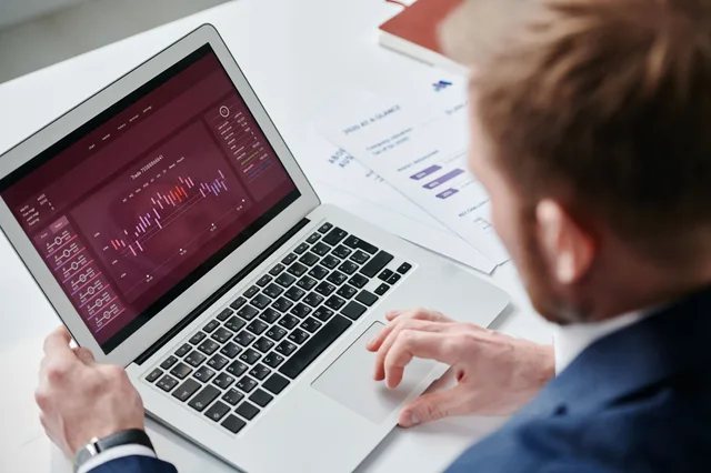 Businessman reviewing data analytics dashboard on laptop in bright office. Scoring a paid retention diagnostic: fee, timeline and store access to grant