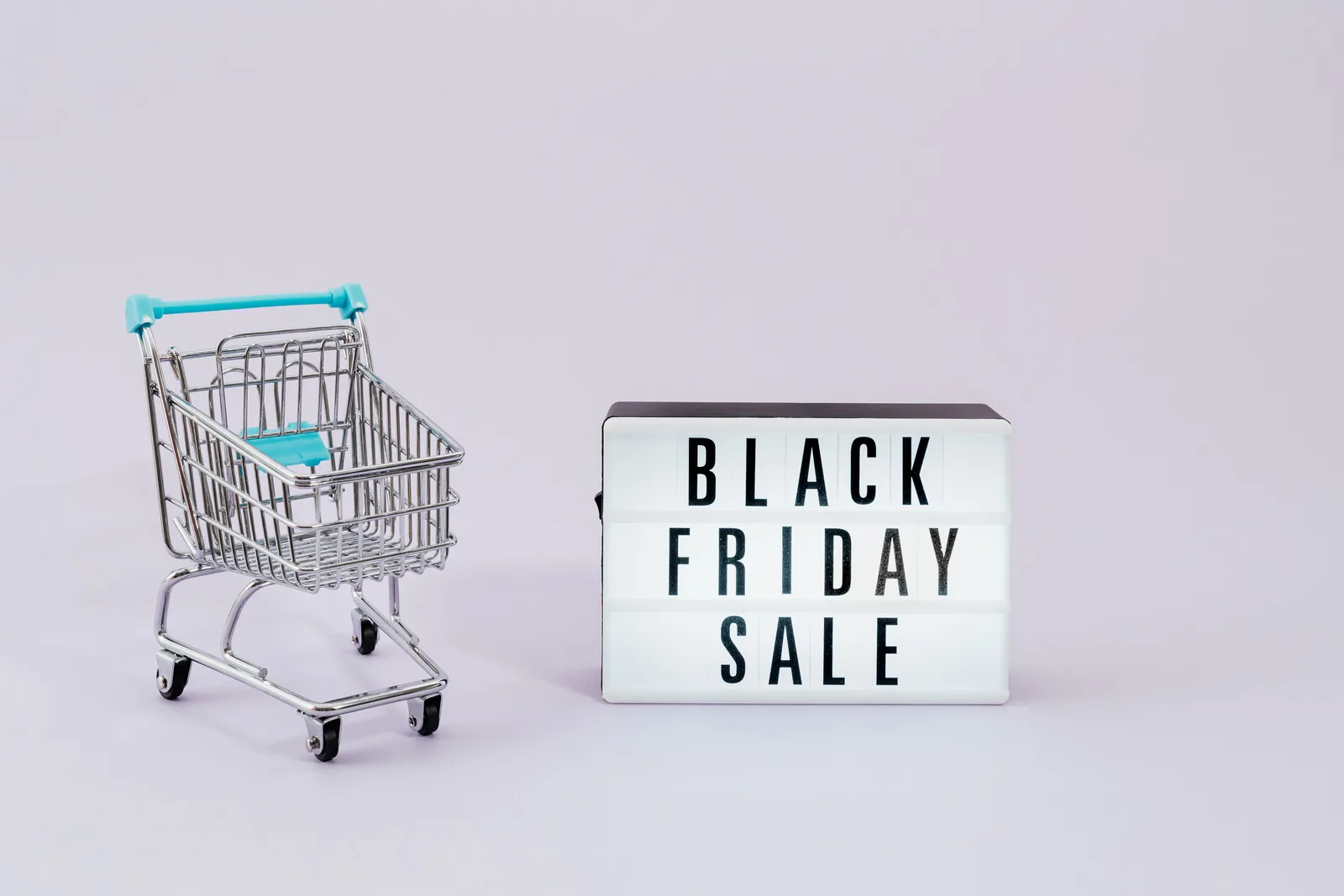 Minimalist image of shopping cart and Black Friday sale sign, perfect for retail promotions. Ecommerce marketing strategy case studies: two FTC enforcement lessons