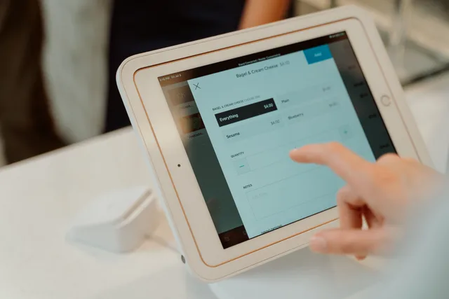 A person uses a tablet-based point-of-sale system by selecting options on a touchscreen device. The ecommerce marketing strategy checklist that catches what audits miss