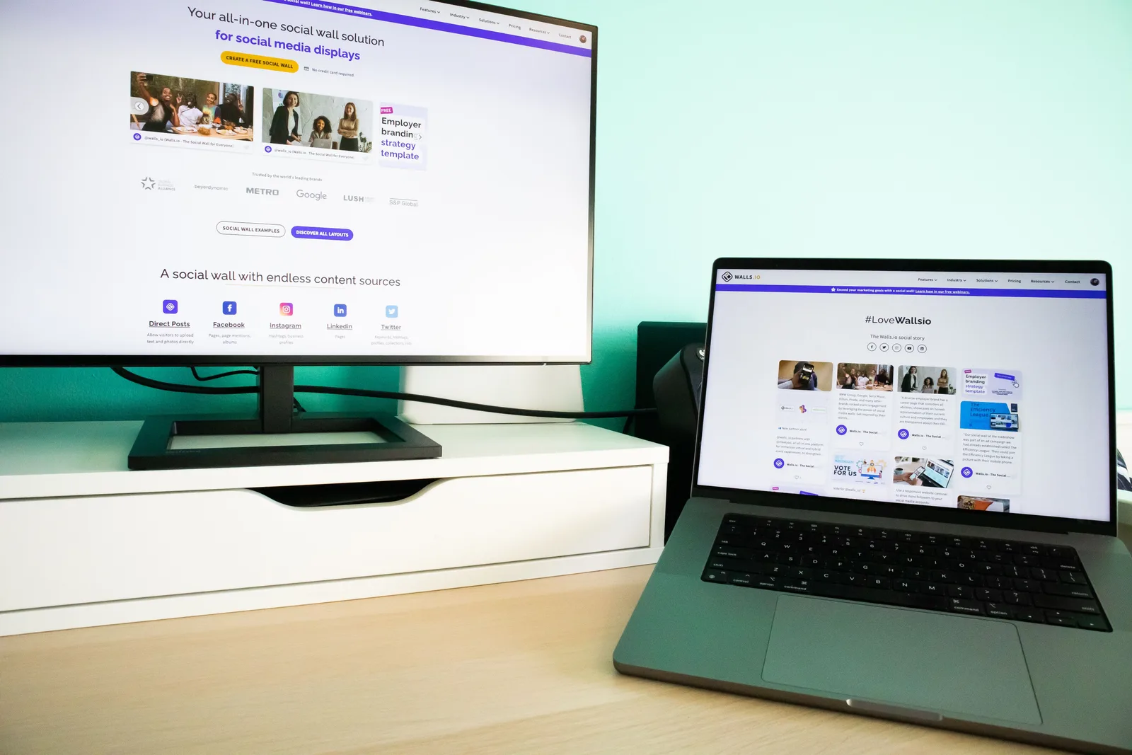 Office desk workspace with a laptop and a monitor displaying a social media wall solution. Ecommerce marketing strategy tools under review: the good, the weak and the verdict